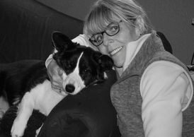 A woman holding her dog in front of the camera.