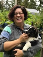 A woman holding a cat in her arms.